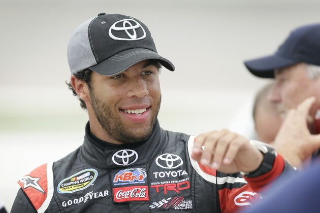 Darrell Wallace Jr. reacts with crew members after winning the pole position during qualifying for the NASCAR Trucks Series auto race, Friday, July 11, 2014, at Iowa Speedway in Newton, Iowa. (AP Photo/Charlie Neibergall)