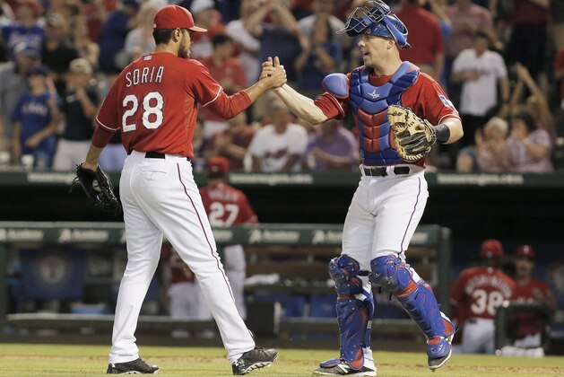 Texas Rangers relief pitcher Joakim Soria (28) and catcher Chris Gimenez (60) congratulate each other after a baseball game against the Cleveland Indians, Friday, June 6, 2014, in Arlington, Texas. Texas won 6-4. (AP Photo/Brandon Wade)