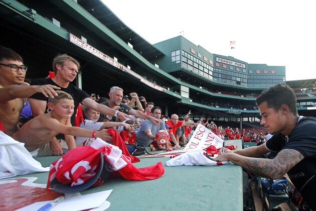 Liverpool F.C. midfielder Philippe Coutinho signs autographs for fans after team practice at Fenway Park in Boston, Tuesday, July 22, 2014. Liverpool will play a friendly soccer match against A.S. Roma on Wednesday. (AP Photo) Liverpool F.C. midfielder Philippe Coutinho signs autographs for fans after team practice at Fenway Park in Boston, Tuesday, July 22, 2014. Liverpool will play a friendly soccer match against A.S. Roma on Wednesday. (AP Photo)