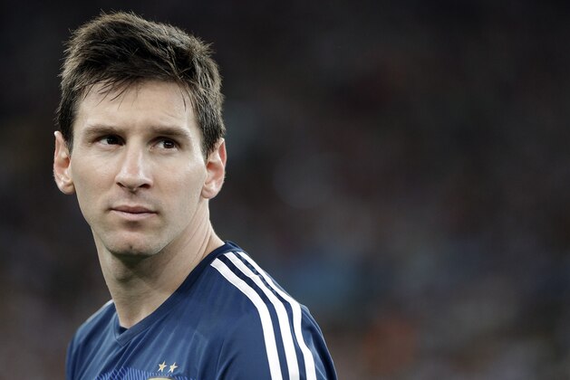 Argentina's Lionel Messi looks back as he goes up to get his runner-up medal after the World Cup final soccer match between Germany and Argentina at the Maracana Stadium in Rio de Janeiro, Brazil, Sunday, July 13, 2014. Germany won the match 1-0. (AP Photo/Matthias Schrader)