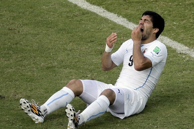 FILE - In this June 24, 2014 file photo, Uruguay's Luis Suarez reacts on the pitch during the group D World Cup soccer match between Italy and Uruguay at the Arena das Dunas in Natal, Brazil. On Thursday, June 26, 2014, FIFA banned Suarez for 9 games and 4 months for biting his opponent at the World Cup. (AP Photo/Hassan Ammar, File) FILE - In this June 24, 2014 file photo, Uruguay's Luis Suarez reacts on the pitch during the group D World Cup soccer match between Italy and Uruguay at the Arena das Dunas in Natal, Brazil. On Thursday, June 26, 2014, FIFA banned Suarez for 9 games and 4 months for biting his opponent at the World Cup. (AP Photo/Hassan Ammar, File)
