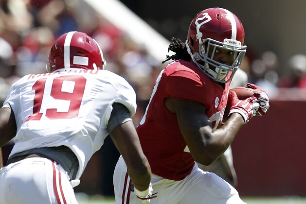 Alabama running back Derrick Henry (27) caries the ball as Alabama linebacker Reggie Ragland (19) closes in during Alabama's A-Day NCAA college football spring game Saturday, April 19, 2014, in Tuscaloosa, Ala. (AP Photo/Butch Dill) Alabama running back Derrick Henry (27) caries the ball as Alabama linebacker Reggie Ragland (19) closes in during Alabama's A-Day NCAA college football spring game Saturday, April 19, 2014, in Tuscaloosa, Ala. (AP Photo/Butch Dill)