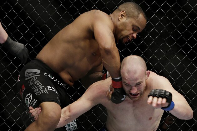Daniel Cormier punches Patrick Cummins during a UFC 170 mixed martial arts light heavyweight fight Saturday, Feb. 22, 2014, in Las Vegas. Cormier won the bout. (AP Photo/Isaac Brekken)