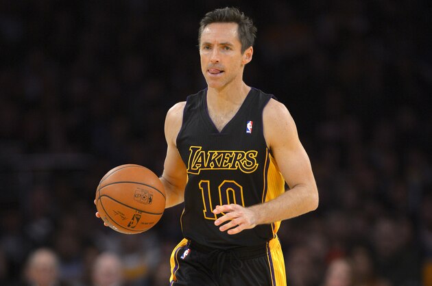 Los Angeles Lakers guard Steve Nash dribbles the ball during the first half of an NBA basketball game against the Washington Wizards, Friday, March 21, 2014, in Los Angeles. (AP Photo/Mark J. Terrill)