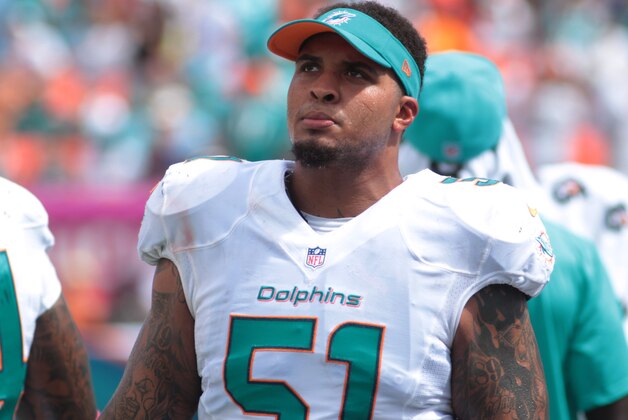 Miami Dolphins center Mike Pouncey (51) on the sidelines during the first half of an NFL football game against the Baltimore Ravens, Sunday, Oct. 6, 2013, in Miami Gardens, Fla. (AP Photo/J Pat Carter    Carter)