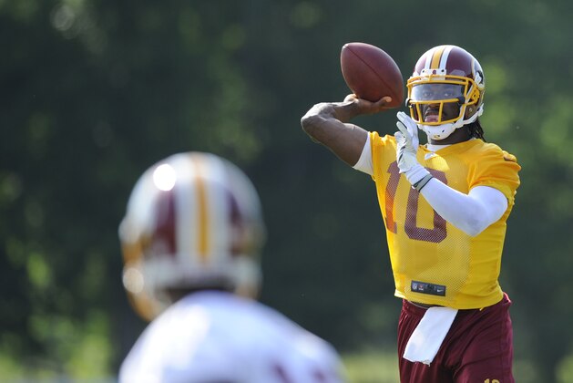 Washington Redskins quarterback Robert Griffin III (10) looks to pass during an NFL football minicamp, Tuesday, June 17, 2014, in Ashburn, Va. (AP Photo/Nick Wass)