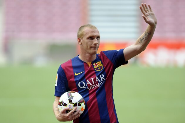 FC Barcelona's new French player Jeremy Mathieu waves during his official presentation at the Camp Nou stadium in Barcelona, Spain, Thursday, July 24, 2014.  Barcelona says it has signed France defender Jeremy Mathieu on a four-year contract with an option to extend it for another season. Barcelona says it has paid 20 million euros ($27 million) for the 30-year-old Mathieu, with a buyout clause fixed at 50 million euros. (AP Photo/Manu Fernandez)