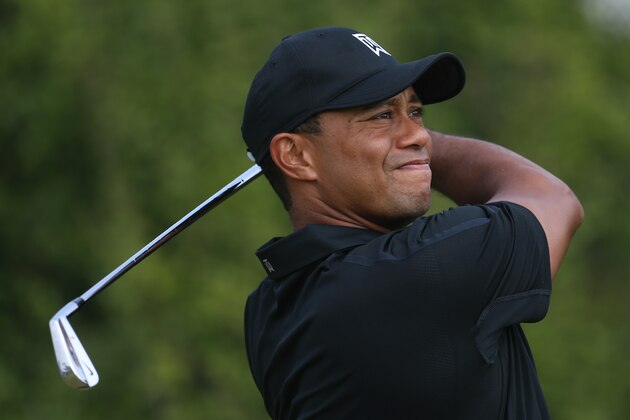 Tiger Woods of the US plays a shot off the 8th tee during the second day of the British Open Golf championship at the Royal Liverpool golf club, Hoylake, England, Friday July 18, 2014. (AP Photo/Peter Morrison)