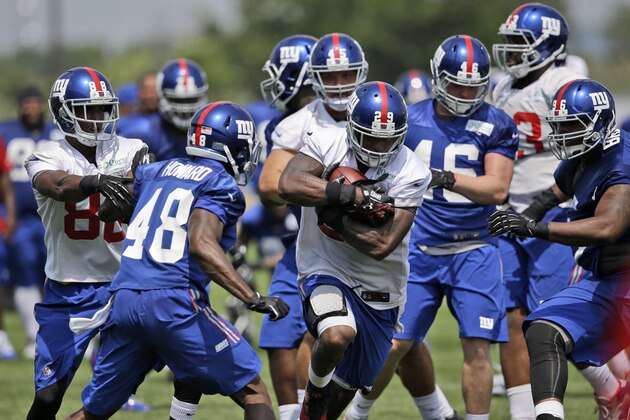 New York Giants' Michael Cox runs through traffic during a NFL football camp in East Rutherford, N.J., Tuesday, July 22, 2014. (AP Photo/Seth Wenig) New York Giants' Michael Cox runs through traffic during a NFL football camp in East Rutherford, N.J., Tuesday, July 22, 2014. (AP Photo/Seth Wenig)