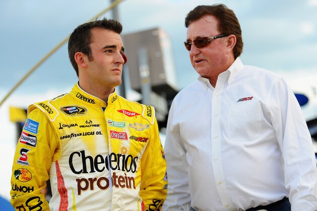 SPARTA, KY - JUNE 28:  Austin Dillon, driver of the #3 Cheerios Protein Chevrolet, left, and team owner and grandfather Richard Childress take part in pre-race ceremonies for the NASCAR Sprint Cup Series Quaker State 400 presented by Advance Auto Parts at Kentucky Speedway on June 28, 2014 in Sparta, Kentucky.  (Photo by Will Schneekloth/Getty Images)