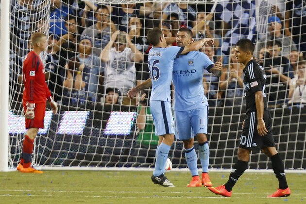 KANSAS CITY, KS - JULY 23: Dedryck Boyata #11 celebrates with Sergio Aguero #16 of Manchester City after scoring a goal past Jon Kempin #21 of Sporting KC during a penalty kick early in the second half on July 23rd at Sporting Park in Kansas City, Kansas. (Photo by Kyle Rivas/Getty Images)