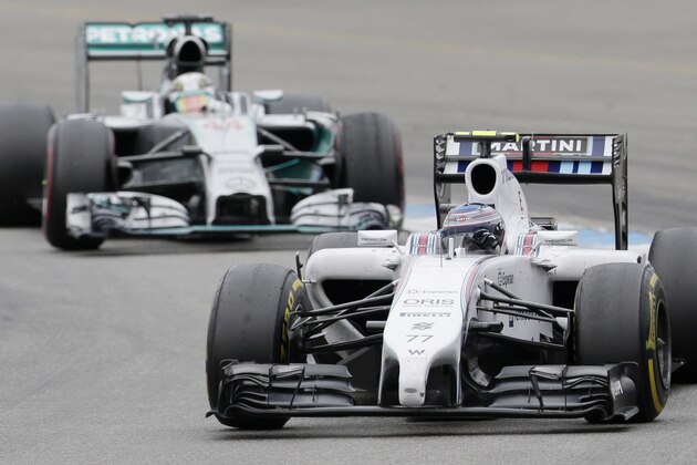Williams driver Valtteri Bottas, right, of Finland steers his car ahead of Mercedes driver Lewis Hamilton, left, of Britain during the German Formula One Grand Prix in Hockenheim, Germany, Sunday, July 20, 2014. Bottas placed second ahead of third placed Hamilton. (AP Photo/Petr David Josek)