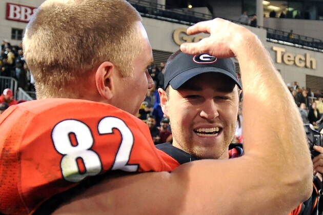 Georgia quarterback Hutson Mason (14) and wide receiver Michael Bennett (82) celebrate after defeating Georgia Tech 41-34 in double overtime during an NCAA football game on Saturday, Nov. 30, 2013, in Atlanta. (AP Photo/David Tulis)