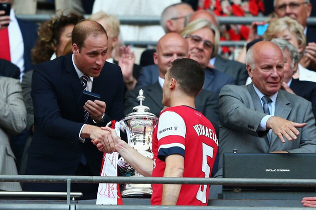 LONDON, ENGLAND - MAY 17:  Captain Thomas Vermaelen of Arsenal shakes hands with Prince William, Duke of Cambridge (L) as FA Chairman Greg Dyke (R) looks on after after the FA Cup with Budweiser Final match between Arsenal and Hull City at Wembley Stadium on May 17, 2014 in London, England.  (Photo by Clive Mason/Getty Images)