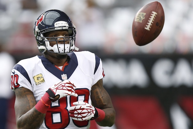 Houston Texans' Andre Johnson flips the ball to quarterback Case Keenum as the team warms up prior to an NFL football game against the Arizona Cardinals on Sunday, Nov. 10, 2013, in Glendale, Ariz. (AP Photo/Ross D. Franklin)