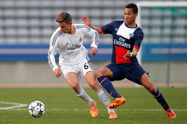 PARIS, FRANCE - MARCH 11:  Mickael Latour of PSG battles for the ball with Marcos Llorente of Real Madrid during the UEFA Youth League Quarter Final match between Paris Saint-Germain FC and Real Madrid at Stade Charlety on March 11, 2014 in Paris, France.  (Photo by Dean Mouhtaropoulos/Getty Images)