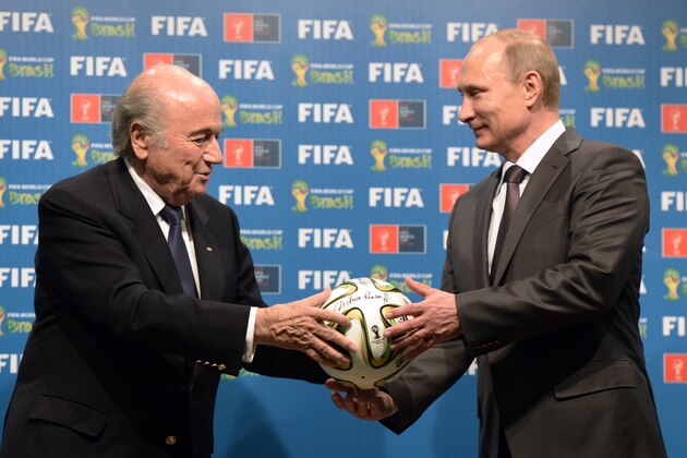 FILE - In this file photo taken on Sunday, July 13, 2014, FIFA President Sepp Blatter, left, and Russian President Vladimir Putin hold a soccer ball during the official ceremony of handover to Russia as the 2018 World Cup hosts, after the World Cup final soccer match between Germany and Argentina at the Maracana Stadium in Rio de Janeiro, Brazil. (AP Photo/RIA-Novosti, Alexei Nikolsky, Presidential Press Service, File)
