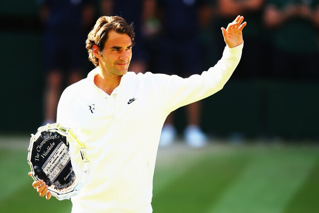 LONDON, ENGLAND - JULY 06:  Roger Federer of Switzerland waves to the fans as he holds the runner up trophy after the Gentlemen's Singles Final match against Novak Djokovic of Serbia on day thirteen of the Wimbledon Lawn Tennis Championships at the All England Lawn Tennis and Croquet Club on July 6, 2014 in London, England.  (Photo by Al Bello/Getty Images)