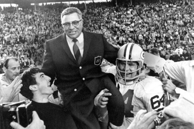Green Bay Packers coach Vince Lombardi is carried off the field after his team defeated the Oakland Raiders 33 to 14 in the Super Bowl II game in Miami, Fla. on Jan. 14, 1968.  Packers guard Jerry Kramer (64) is at right.  (AP Photo)