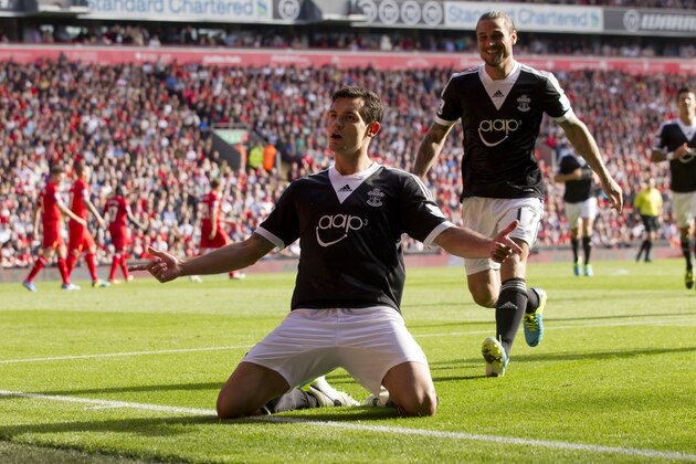 Southampton's Dejan Lovren, centre, celebrates after scoring against Liverpool during their English Premier League soccer match at Anfield Stadium, Liverpool, England, Saturday Sept. 21, 2013. (AP Photo/Jon Super)