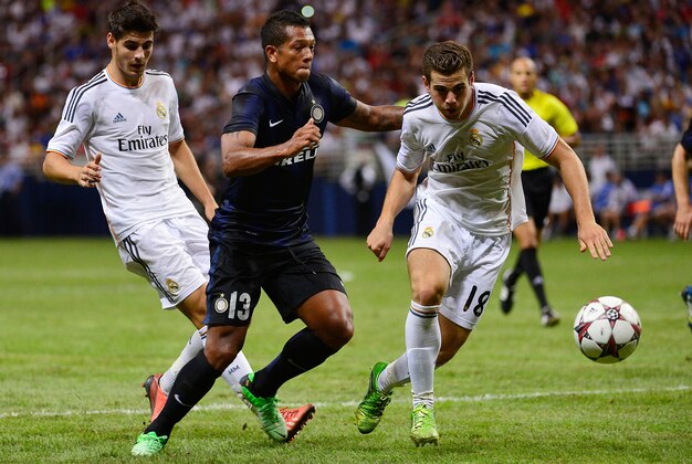 Aug 10, 2013; St. Louis, MO, USA; Real Madrid defender Raul Albiol (18) defends against Inter Milan forward Fredy Guarin (13). Mandatory Credit: Scott Rovak-USA TODAY Sports