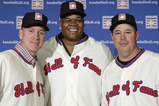 ADVANCE FOR WEEKEND EDITIONS, JULY 26-27 - FILE - In this Jan. 9, 2014 file photo, former Atlanta Braves pitchers Tom Glavine, left, and Greg Maddux, right, pose with Chicago White Sox slugger Frank Thomas after a press conference announcing their election to the 2014 Baseball Hall of Fame class in New York. Induction ceremonies are Sunday, July 27, 2014 in Cooperstown, N.Y. (AP Photo/Kathy Willens, File)