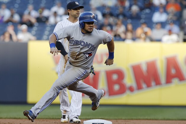 New York Yankees second baseman Brian Roberts (14) watches as Toronto Blue Jays Melky Cabrera turns past second base in a baseball game at Yankee Stadium in New York, Thursday, June 19, 2014.  Cabrera was later picked off at second. (AP Photo/Kathy Willens)