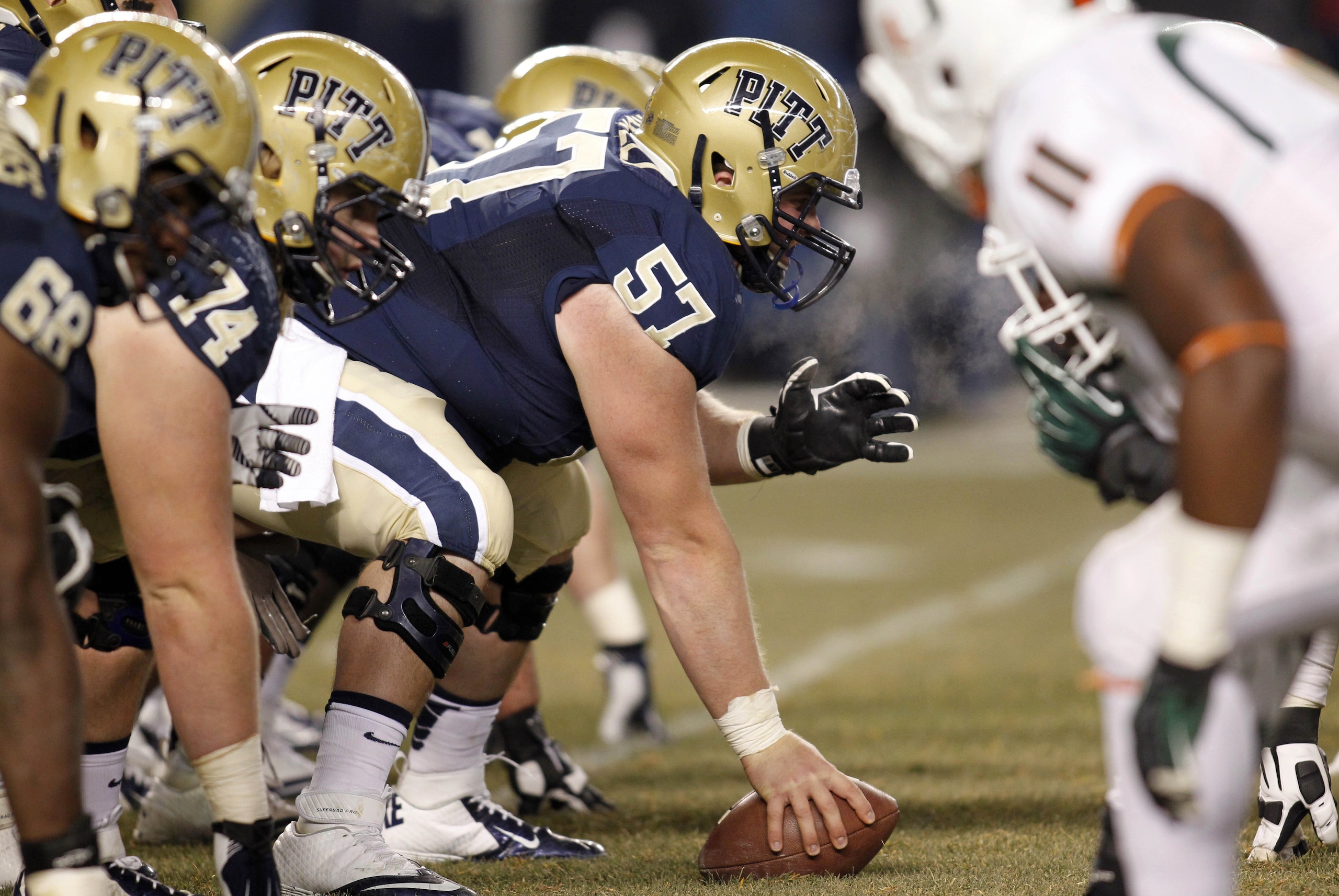 Nov 29, 2013; Pittsburgh, PA, USA; Pittsburgh Panthers offensive linesman Artie Rowell (57) prepares to snap the ball against the Miami Hurricanes during the fourth quarter at Heinz Field. Miami won 41-31. Mandatory Credit: Charles LeClaire-USA TODAY Sports