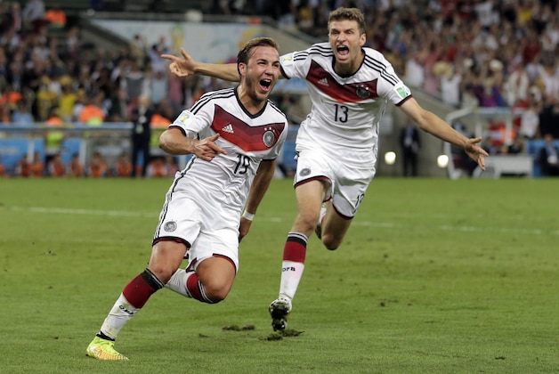 Germany's Mario Goetze (19) celebrates with Thomas Mueller after scoring his side's first goal in extra time against Argentina's goalkeeper Sergio Romero during the World Cup final soccer match between Germany and Argentina at the Maracana Stadium in Rio de Janeiro, Brazil, Sunday, July 13, 2014. (AP Photo/Felipe Dana)
