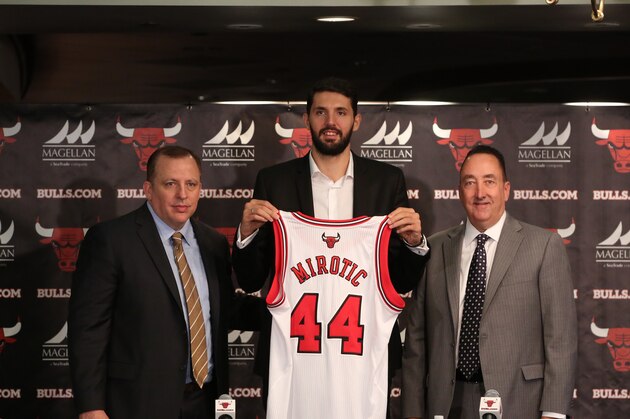 CHICAGO, IL - JULY 18: Chicago Bulls head coach Tom Thibodeau and general manager Gar Forman introduce newly-signed free agent Nikola Mirotic, accompanied by guest translator Igor Ormazabal, during a press conference at the United Center on July 18, 2014  in Chicago, Illinois. NOTE TO USER:  User expressly acknowledges and agrees that, by downloading and or using this Photograph, user is consenting to the terms and conditions of the Getty Images License Agreement.  Mandatory Copyright Notice:  Copyright 2014 NBAE (Photo by Gary Dineen/NBAE via Getty Images)