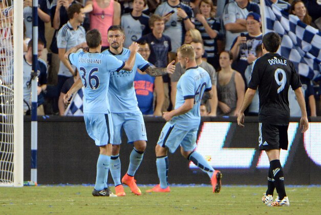 Jul 23, 2014; Kansas City, KS, USA; Manchester City defender Aleksander Kolarov (11) is congratulated by midfielder Bruno Zuculini (36) and forward John Guidetti (60) after scoring against Sporting KC goal keeper Jon Kempin (21) in the second half at Sporting Park. Manchester City won 4-1. Mandatory Credit: John Rieger-USA TODAY Sports