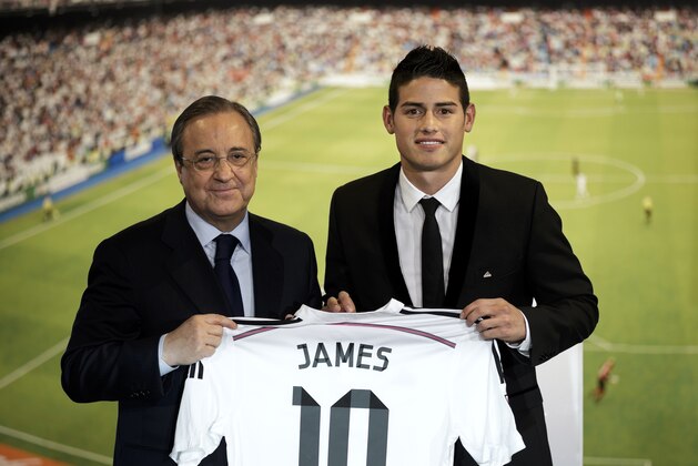 Real Madrid president Florentino Perez, left, and new Real Madrid player James Rodriguez, from Colombia, hold his new shirt and poses for photographers during his official presentation at the Santiago Bernabeu stadium in Madrid, Spain, Tuesday, July 22, 2014, after signing for Real Madrid. Real Madrid have signed Rodriguez from Monaco on a six-year contract. (AP Photo/Daniel Ochoa de Olza)
