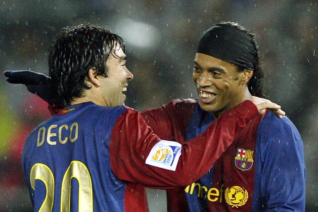 European champion FC Barcelona Ronaldinho of Brazil, right, is congratulated by his teammate Deco of Portugal after he scored the Spanish team's third goal against their  North and Central American counterpart Club America of Mexico during the semi-final of Club World Cup soccer in Yokohama, near Tokyo, Thursday, Dec. 14, 2006. (AP Photo/David Guttenfelder)