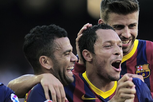 FC Barcelona's Daniel Alves, from Brazil, left, reacts after scoring with his teammates Adriano, from Brazil, second left, Gerard Pique, second right, and Lionel Messi, from Argentina, against Levante during a Spanish La Liga soccer match at the Camp Nou stadium in Barcelona, Spain, Sunday, Aug. 18, 2013. (AP Photo/Manu Fernandez)