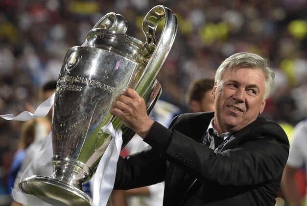 Real's coach Carlo Ancelotti lifts the Champion League trophy after his team won, at the end of the Champions League final soccer match between Atletico Madrid and Real Madrid in Lisbon, Portugal, Saturday, May 24, 2014.(AP Photo/Manu Fernandez)