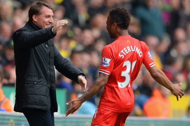 NORWICH, ENGLAND - APRIL 20:  Raheem Sterling of Liverpool celebrates scoring the opening goal with Manager Brendan Rodgers of Liverpool during the Barclays Premier League match between Norwich City and Liverpool at Carrow Road on April 20, 2014 in Norwich, England.  (Photo by Michael Regan/Getty Images)