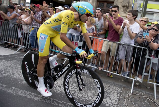 Italy's Vincenzo Nibali, wearing the overall leader's yellow jersey, crosses the finish line of the twentieth stage of the Tour de France cycling race, an individual time-trial over 54 kilometers (33.6 miles) with start in Bergerac and finish in Perigueux, France, Saturday, July 26, 2014. (AP Photo/Peter Dejong)