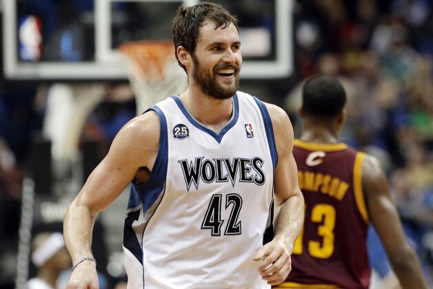 Minnesota Timberwolves' Kevin Love smiles after a three-point shot in the second half of an NBA basketball game against the Cleveland Cavaliers, Wednesday, Nov. 13, 2013, in Minneapolis. Love led the Timberwolves with 33 points in the team's 124-95 win. (AP Photo/Jim Mone)