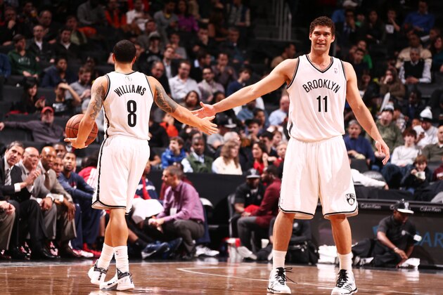 NEW YORK, NY - DECEMBER 18: Deron Williams #8 of the Brooklyn Nets high fives teammate Brook Lopez #11 during a game against  the Washington Wizards at the Barclays Center on December 18, 2013 in the Brooklyn borough of New York City.  NOTE TO USER: User expressly acknowledges and agrees that, by downloading and/or using this Photograph, user is consenting to the terms and conditions of the Getty Images License Agreement. Mandatory Copyright Notice: Copyright 2013 NBAE (Photo by Nathaniel S. Butler/NBAE via Getty Images)