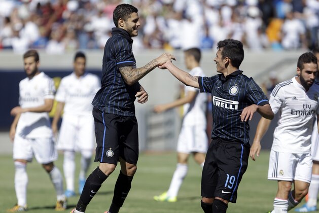 Inter Milan's Mauro Icardi, left, is congratulated by Ruben Botta (19) after Icardi scored a goal against Real Madrid during the second half of a soccer match in the first round of the Guinness International Champions Cup, Saturday, July 26, 2014, in Berkeley, Calif. (AP Photo/Ben Margot)
