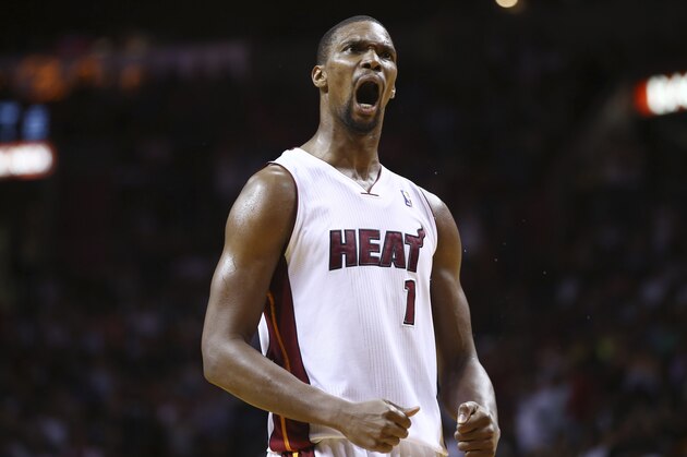 Miami Heat's Chris Bosh reacts after LeBron James scored a three point shot during the second half of an NBA  basketball game in Miami, Monday, March 10, 2014 against the Washington Wizards. The Heat won 99-90. (AP Photo/J Pat Carter)
