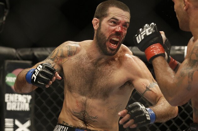 Matt Brown, left, throws a punch at Robbie Lawler  during the fifth round of a welterweight mixed martial arts bout at a UFC on Fox event in San Jose, Calif., Saturday, July 26, 2014. Lawler won by unanimous decision. (AP Photo/Jeff Chiu)