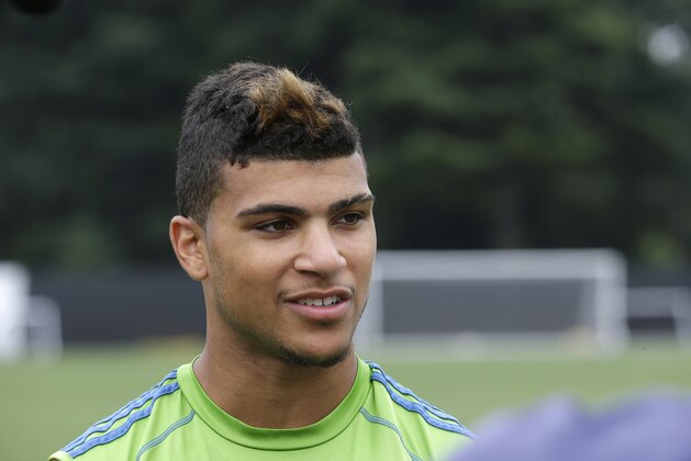 Seattle Sounders FC's DeAndre Yedlin talks to the media, Monday, July 7, 2014, following training with his team in Tukwila, Wash. Yedlin rejoined the Sounders on Monday after playing on the U.S. Men's National Team in the World Cup and he is expected to be available for both of Seattle's matches this week against rival Portland — in the U.S. Open Cup on Wednesday and then in MLS play Sunday. Yedlin did not comment directly on reports coming from Italy about a pending deal that would see the 20-year-old defender move to AS Roma in 2015 after completing this season with Seattle. (AP Photo/Ted S. Warren)