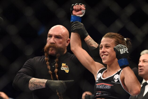 July 26, 2014; San Jose, CA, USA; Joanna Jedrzejczyk (blue gloves) celebrates her victory against Juliana Lima (red gloves) following the women   s strawweight bout of the FOX UFC Saturday at SAP Center. Mandatory Credit: Kyle Terada-USA TODAY Sports