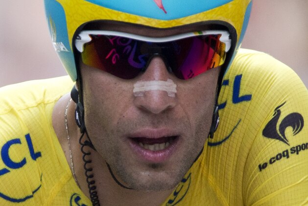 Italy's Vincenzo Nibali, wearing the overall leader's yellow jersey, crosses the finish line of the twentieth stage of the Tour de France cycling race, an individual time-trial over 54 kilometers (33.6 miles) with start in Bergerac and finish in Perigueux, France, Saturday, July 26, 2014. (AP Photo/Peter Dejong)