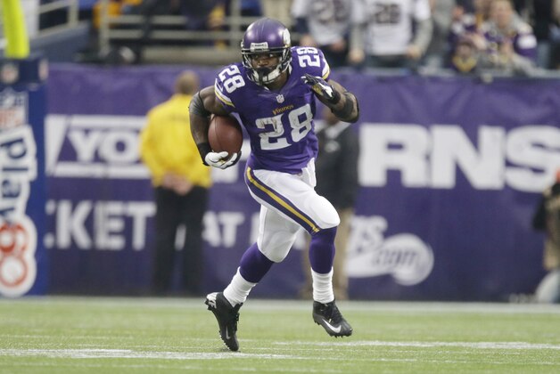 Minnesota Vikings running back Adrian Peterson (28) rushes for extra yardage in an an NFL football game against the Chicago Bears, Sunday, Dec. 1, 2013, in Minneapolis. (AP Photo/Jim Mone)
