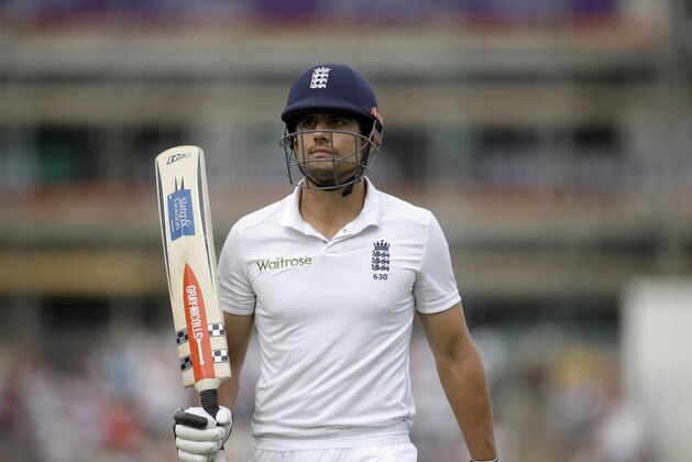 England captain Alastair Cook holds up his bat to acknowledge applause from the crowd as he walks off the field of play after losing his wicket off the bowling of Ravindra Jadeja, scoring 95 runs during the first day of the third cricket test match of the series between England and India at The Ageas Bowl in Southampton, England, Sunday, July 27, 2014.  (AP Photo/Matt Dunham)