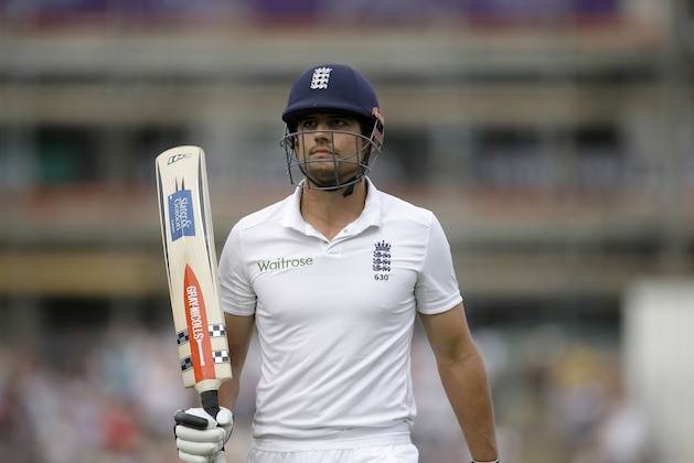 England captain Alastair Cook holds up his bat to acknowledge applause from the crowd as he walks off the field of play after losing his wicket off the bowling of Ravindra Jadeja, scoring 95 runs during the first day of the third cricket test match of the series between England and India at The Ageas Bowl in Southampton, England, Sunday, July 27, 2014.  (AP Photo/Matt Dunham)