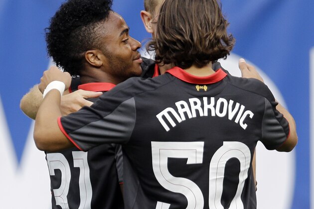 Liverpool FC forward Raheem Sterling (31) celebrates with midfielders Jordan Henderson and Lazar Markovic (50) after scoring a goal during the first half of a Guinness International Champions Cup soccer match against Olympiacos in Chicago, Sunday, July 27, 2014. (AP Photo/Nam Y. Huh)