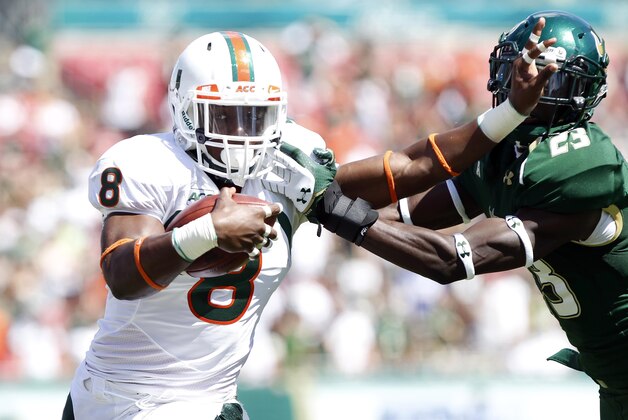 Sep 28, 2013; Tampa, FL, USA; Miami Hurricanes running back Duke Johnson (8) stiff arms South Florida Bulls defensive back Kenneth Durden (23) during the first quarter at Raymond James Stadium. Mandatory Credit: Kim Klement-USA TODAY Sports